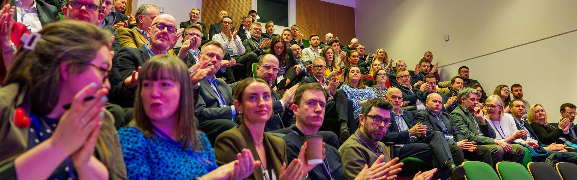 People clapping at a conference 
